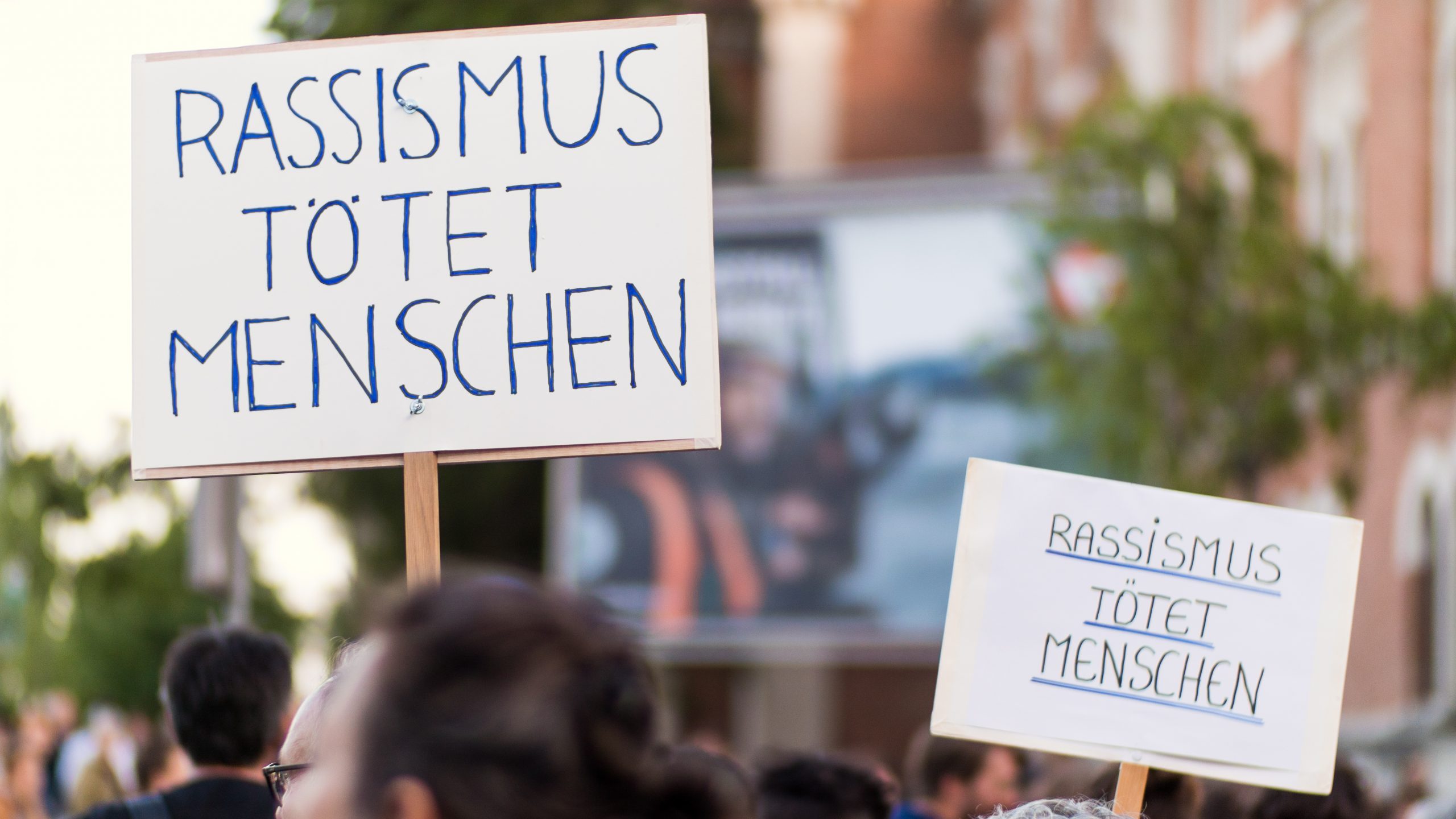 Protestplakate mit dem Text Rassismus tötet Menschen