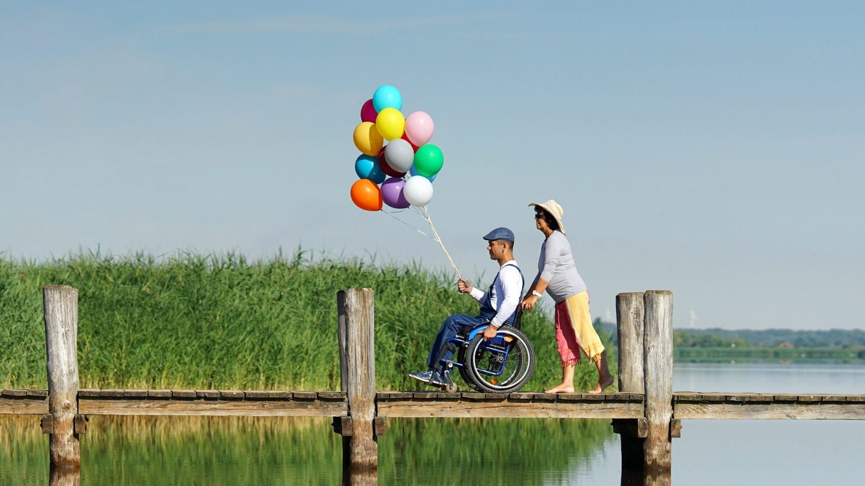 man in wheelchair enjoying his freedom at lake