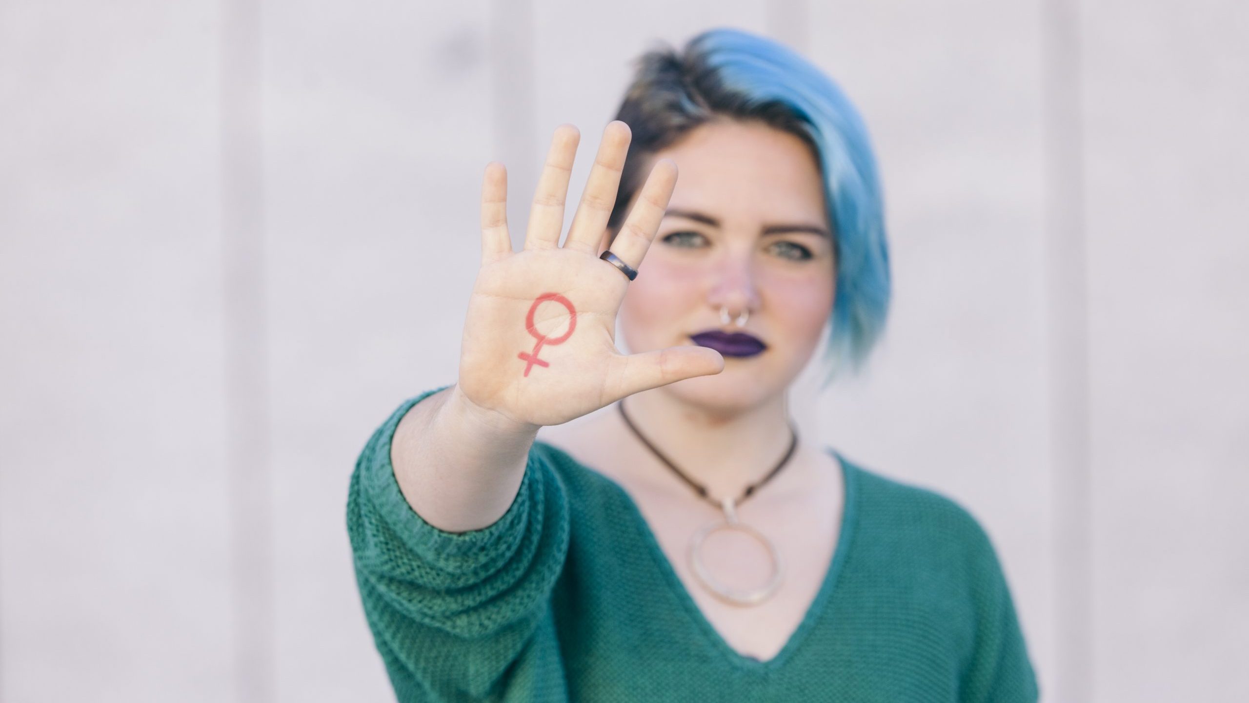 symbol of feminism written on a woman hand isolated on the stree