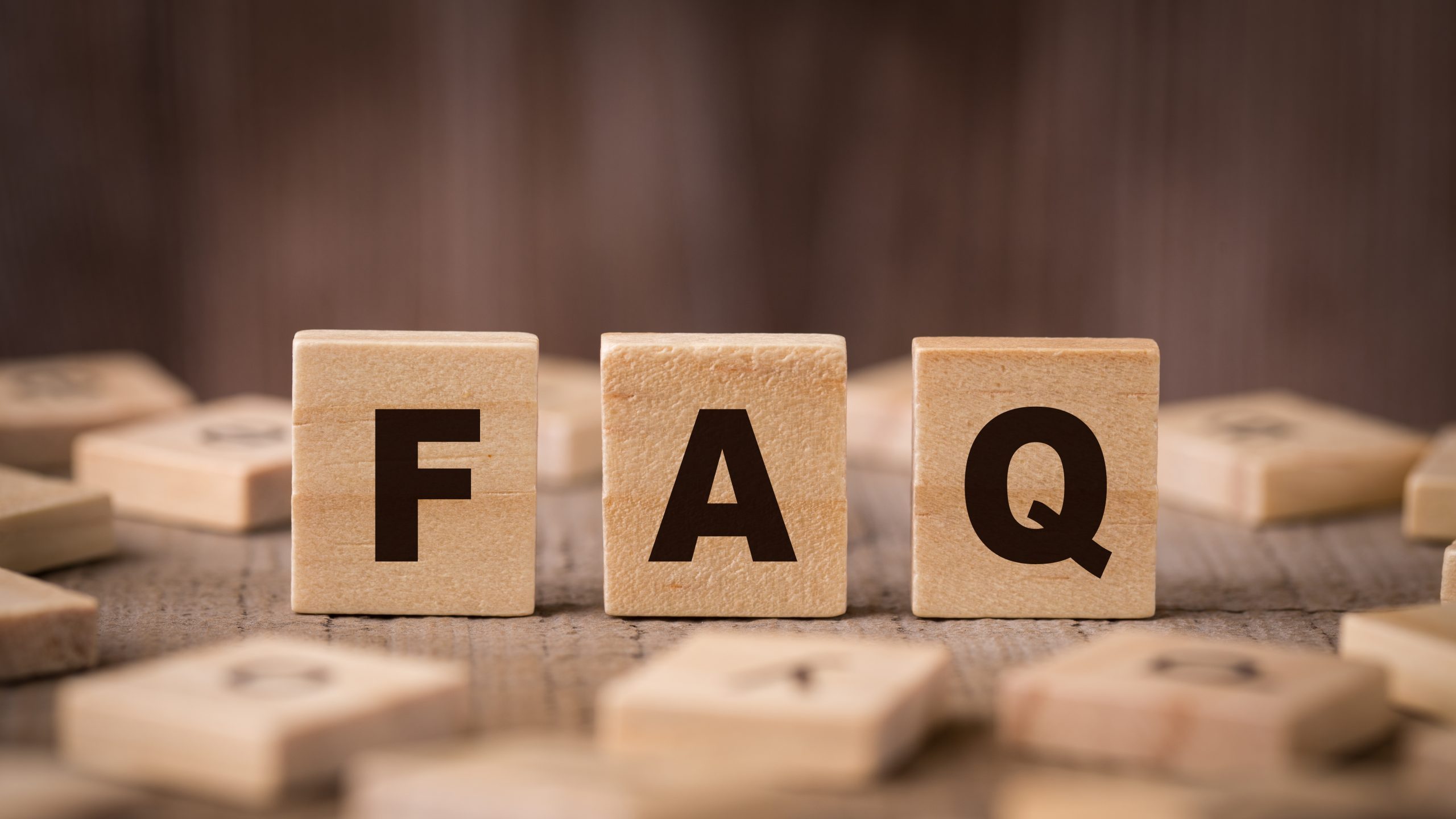 FAQ Sign With Wooden Background